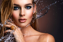 Photo Of Young Woman With Style Make-up And Water Splashes  . Portrait Of Blonde Woman With Drops Of Water Around Her Face. Sexy Girl With Blue Eye Makeup. Fashion Model And Water.
