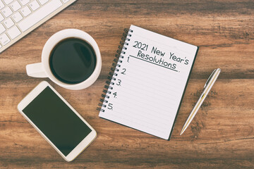 Wall Mural - 2021 New Year resolution text on notepad with cup of coffee, smart phone, pen