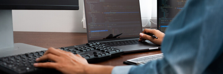 Software developer or programmer working data debugging improvement binary algorithm on desktop pc in a software develop company office.