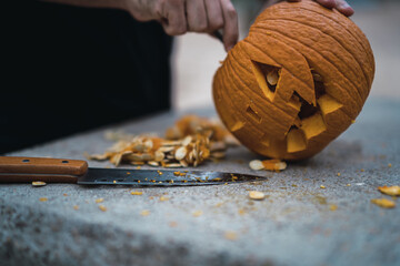 Poster - Man carving and preparing a pumpkin for Halloween