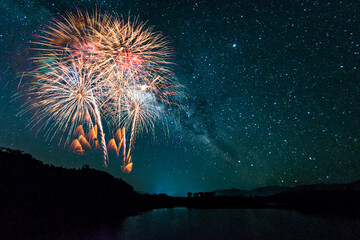 Wall Mural - colorful of fireworks display on milkyway in night sky background.