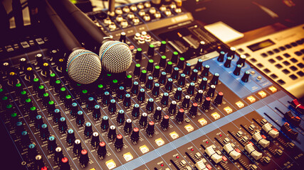 Close-up microphones and audio mixer in studio concepts room for sound control and recording equipment and music instrument.