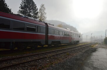 Wall Mural - red train and foggy morning