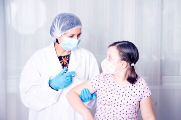 Vaccination concept. Female doctor vaccinating cute little girl in clinic.