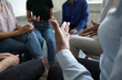 © fizkes - Sharing ideas. Close up view of diverse people group gathered in circle at workplace office cabinet to discuss work or self problems, share points of view, listen to mates, feel psychological support