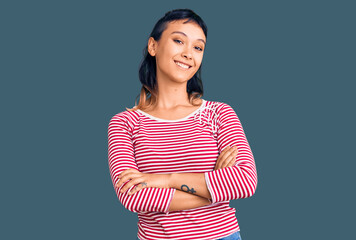 Wall Mural - Young woman wearing casual clothes happy face smiling with crossed arms looking at the camera. positive person.