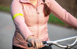 Close up of a detail to reflective yellow slap, tape or element clothing on the hands, transport safety concept