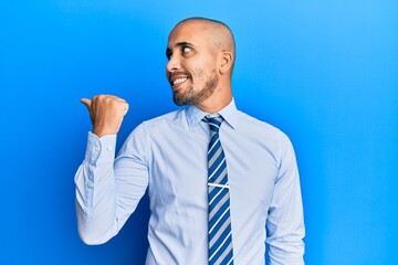 Sticker - Hispanic adult man wearing business shirt and tie pointing thumb up to the side smiling happy with open mouth