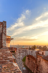 Wall Mural - Beautiful sunset over Brescia city view from the old castle. Lombardy, Italy (Vertical photo)