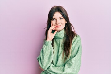 Sticker - Young beautiful caucasian girl wearing wool sweater smiling looking confident at the camera with crossed arms and hand on chin. thinking positive.