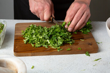 Wall Mural - Man chopping fresh greens for food