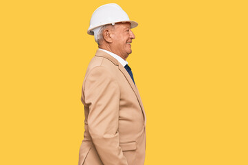 Sticker - Senior caucasian man wearing architect hardhat looking to side, relax profile pose with natural face with confident smile.