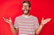 © Krakenimages.com - Handsome caucasian man with beard wearing casual clothes and glasses celebrating mad and crazy for success with arms raised and closed eyes screaming excited. winner concept