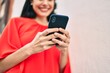 © Krakenimages.com - Young latin girl smiling happy using smartphone at the city.