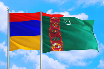 Wall Mural - Turkmenistan and Armenia national flag waving in the windy deep blue sky. Diplomacy and international relations concept.