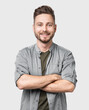 © kite_rin - Portrait of handsome smiling young man with crossed arms. Laughing cheerful men with crossed hands studio shot. Isolated on gray background