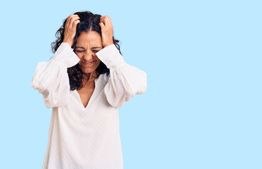 Wall Mural - Middle age beautiful woman wearing casual sweater suffering from headache desperate and stressed because pain and migraine. hands on head.