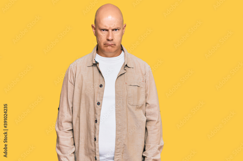 Middle age bald man wearing casual clothes skeptic and nervous, frowning upset because of problem. negative person.