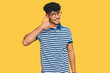 © Krakenimages.com - Young arab man wearing casual clothes and glasses smiling doing phone gesture with hand and fingers like talking on the telephone. communicating concepts.