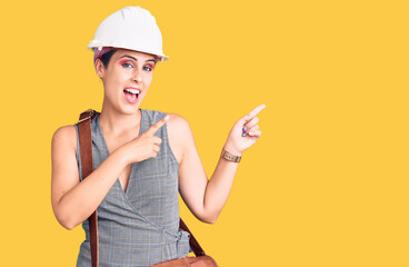 Sticker - Young beautiful woman wearing architect hardhat and leather bag smiling and looking at the camera pointing with two hands and fingers to the side.