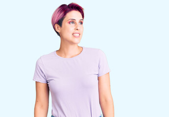 Sticker - Young beautiful woman with pink hair wearing casual clothes looking away to side with smile on face, natural expression. laughing confident.