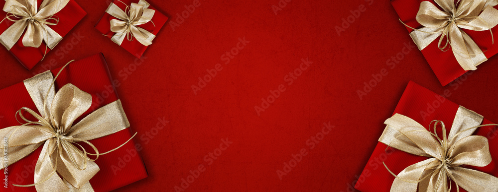 merry christmas, top view of wrapped gift present packages with golden ribbon bow, isolated on red background, useful as a greeting gift card - obrazy, fototapety, plakaty 