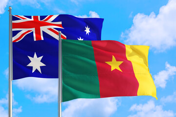 Cameroon and Australia national flag waving in the windy deep blue sky. Diplomacy and international relations concept.