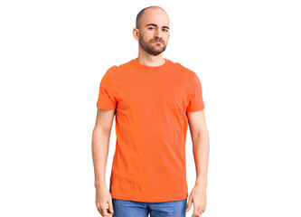 Poster - Young handsome man wering casual t shirt relaxed with serious expression on face. simple and natural looking at the camera.