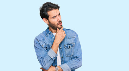 Young hispanic man wearing casual clothes thinking worried about a question, concerned and nervous with hand on chin