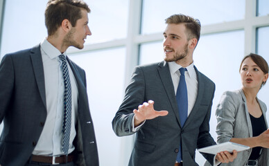 Wall Mural - three employees discussing new opportunities.