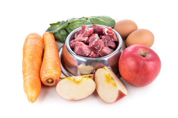 Wall Mural - Ingredients of barf raw food recipe for dogs consisting meat, eggs and vegetable