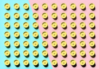 Abstract colorful mock up scene with yellow cylinders on cyan and pink background; many rows of round pills on two-tone backdrop; top view; 3d rendering, 3d illustration