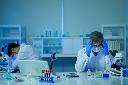 Depressed and stressful scientist in laboratory, Science and technology healthcare concept