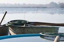 Vats And Fishing Nets On The Shore Of A Pond During Traditional Autumn Carp Haul