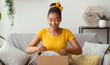 © Prostock-studio - Happy black woman unpacking box after online shopping