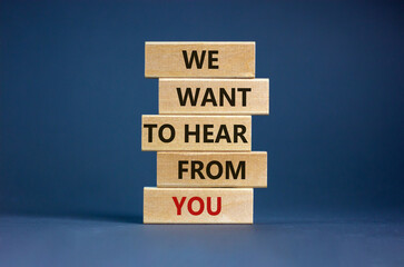 Wall Mural - Wooden blocks with words 'we want to hear from you'. Beautiful grey background. Copy space. Business concept.