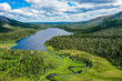 Aerial view of a blue lake, mountains  and forest in Finnish Lapland