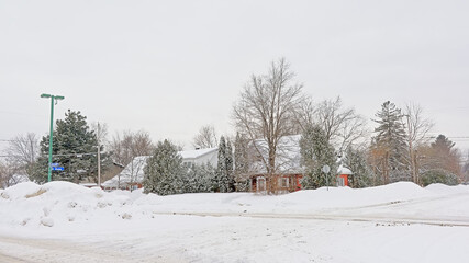 Wall Mural - Typical canadian houses with big heaps of snow in front on a cold grey winter day in Gatineau, Quebec, Canada 