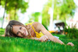 © Andrey_Arkusha - Portrait of a young girl lying on green grass