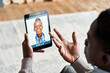 © insta_photos - Over shoulder view of african man video calling female virtual doctor consulting patient on tablet at home. Online telemedicine chat visit meeting. Ehealth, telehealth consultation, tele medicine.