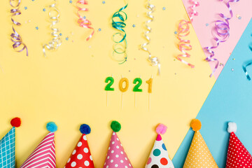 Wall Mural - 2021 party theme with with hats and streamers on a vibrant background