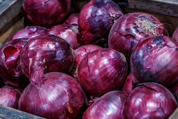 Wall Mural - Red onions in plenty on display at local farmer's market, Big fresh red onions background.red onions on rustic wood