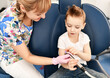 © Dmitry Lobanov - Moscow, Russia - 18 March, 2019:  Children dentist shows special dental tool to a kid boy in dental chair in stomatologist office