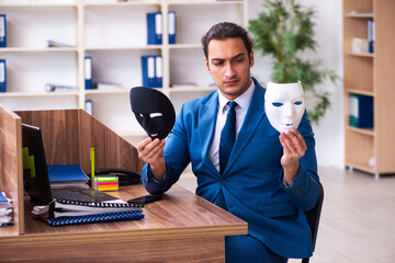 Wall Mural - Young male employee wearing mask in the office