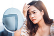© Have a nice day  - Asian beautiful woman self awareness lack confidence spots pimple zits face problem feeling stress sad worry concern bad unhealthy skin care aging issues looking into mirror, at home in living room