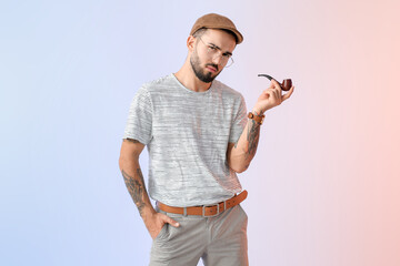 Wall Mural - Fashionable young man on light color background