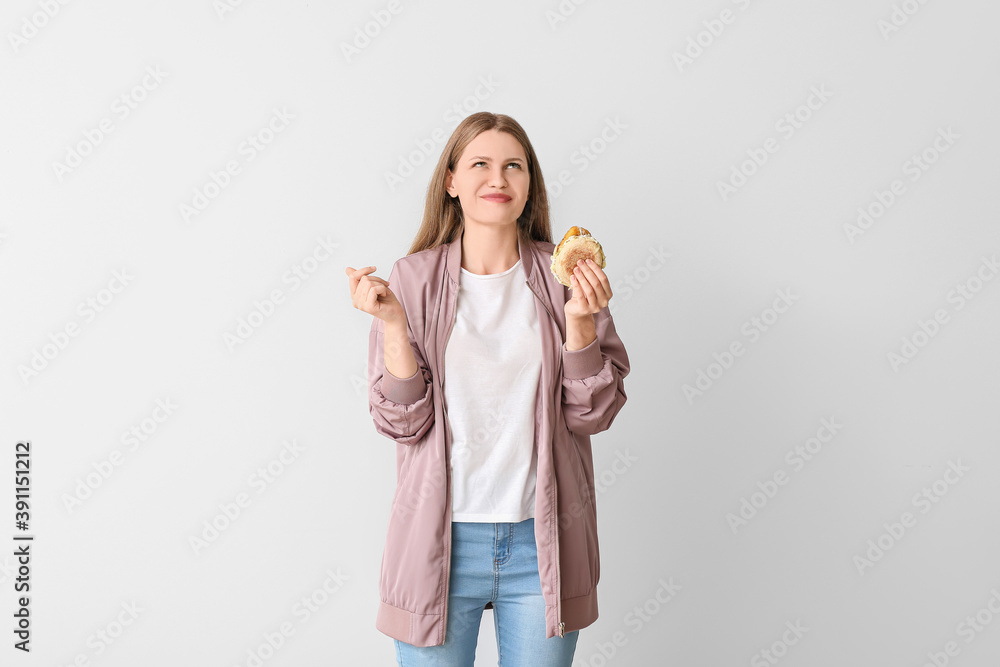 Woman with problem of strong hunger on light background. Diabetes symptoms