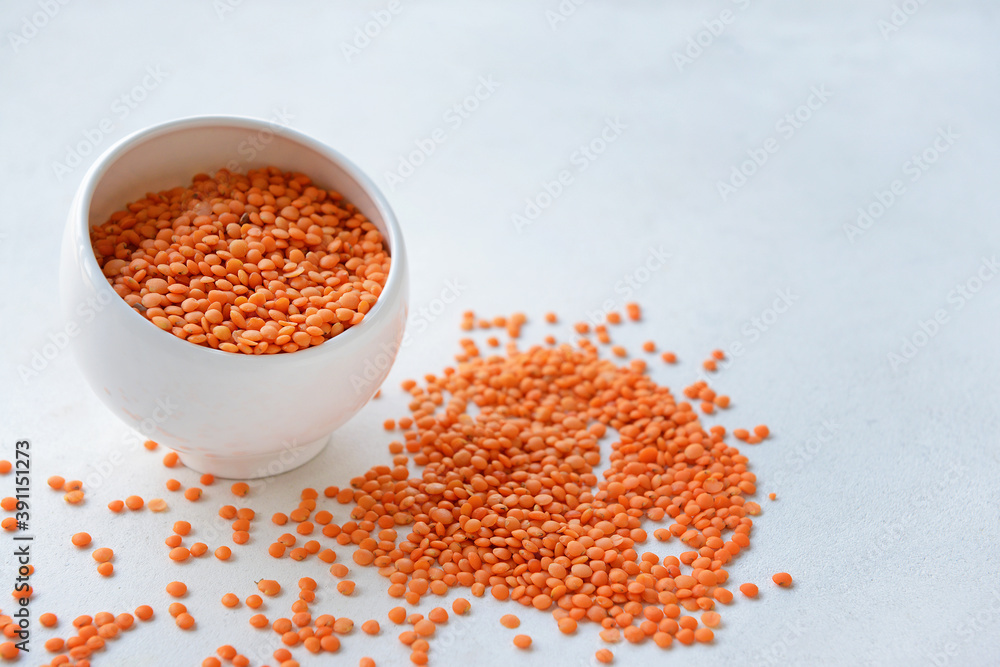 Bowl with raw lentils on light table