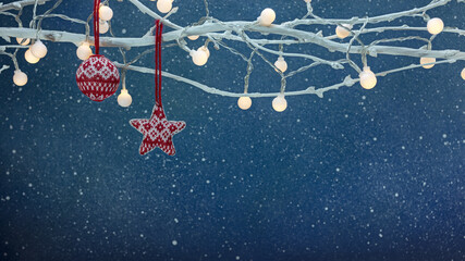 Wall Mural - christmas tree decorations and lights hanging on bare tree branches against dark blue background. new year holidays.