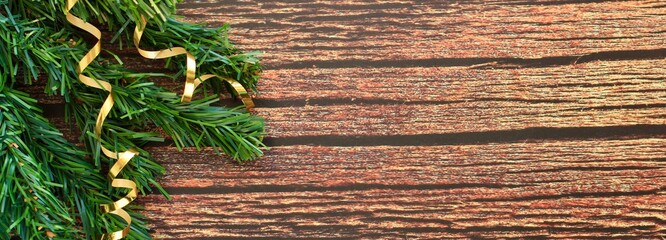 Wall Mural - Christmas tree toys on branches of spruce on  a wooden background. New Year, winter holidays banner.